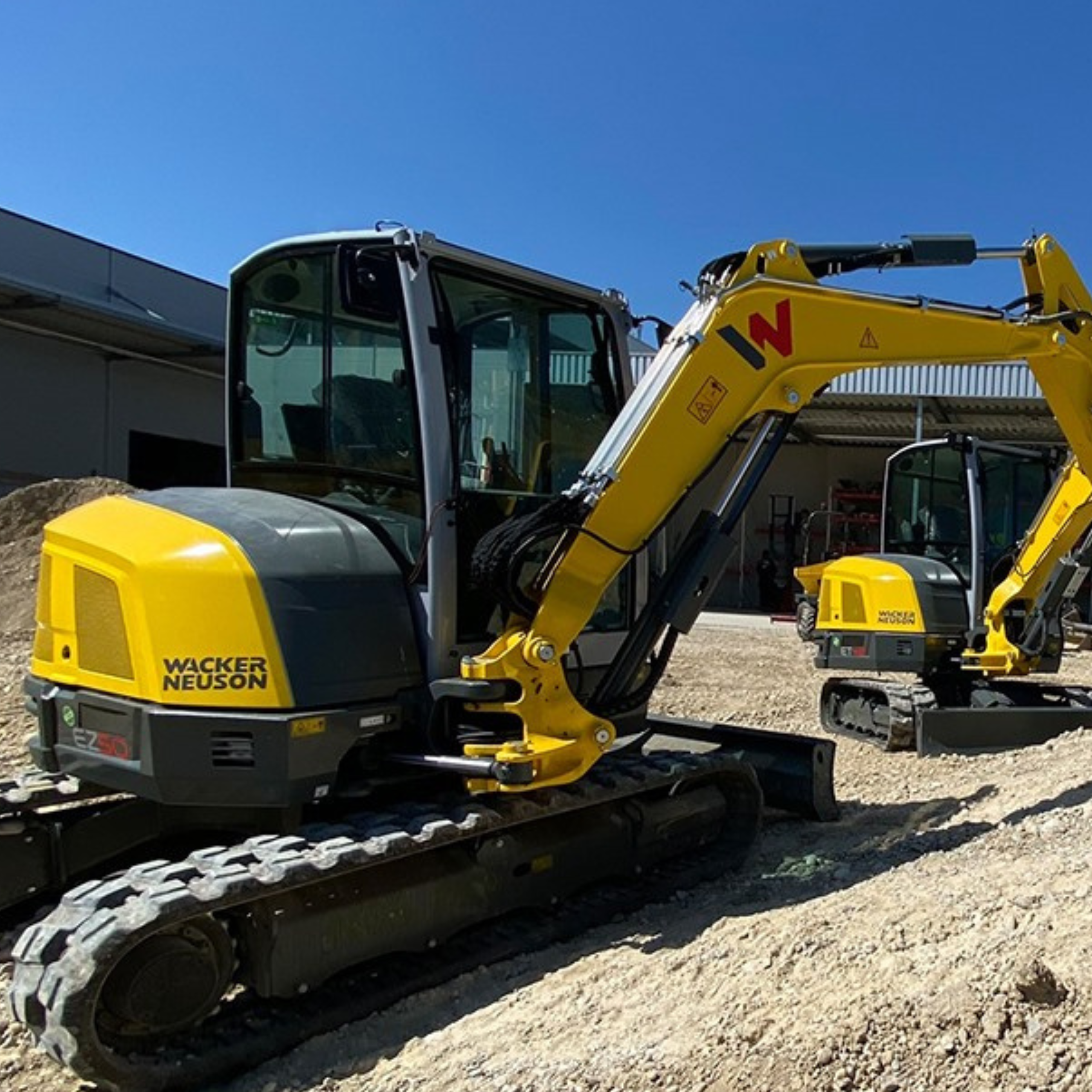 Wacker Neuson mini excavators working on a slope near Tri-County Equipment in Crossville, TN